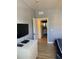 Bedroom showcasing a view into the en-suite bathroom with a TV at 3006 Bonfire Beach Dr # 102, Kissimmee, FL 34746