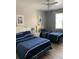 Bright bedroom featuring two twin beds, nightstands and window with curtains at 3006 Bonfire Beach Dr # 102, Kissimmee, FL 34746