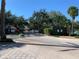 Gated community entrance with landscaped medians and a controlled access point at 3006 Bonfire Beach Dr # 102, Kissimmee, FL 34746