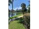 Peaceful walkway along the lake with lush landscaping and beautiful homes in the background at 3006 Bonfire Beach Dr # 102, Kissimmee, FL 34746