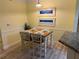 Charming dining area featuring a wooden table and chairs, perfect for intimate meals at 3006 Bonfire Beach Dr # 102, Kissimmee, FL 34746