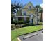 Charming yellow two-story home with a green door and well-maintained landscaping at 3006 Bonfire Beach Dr # 102, Kissimmee, FL 34746