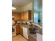 Kitchen with granite countertops, stainless steel sink, and a view to the living area at 3006 Bonfire Beach Dr # 102, Kissimmee, FL 34746
