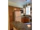 Traditional kitchen featuring granite counters, wooden cabinets, and white appliances at 3006 Bonfire Beach Dr # 102, Kissimmee, FL 34746