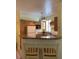 Well-equipped kitchen with wood cabinetry and a breakfast bar with seating at 3006 Bonfire Beach Dr # 102, Kissimmee, FL 34746