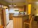 Open kitchen boasts granite countertops, wood cabinets, and modern appliances at 3006 Bonfire Beach Dr # 102, Kissimmee, FL 34746