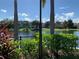 Scenic view of a lake, lush greenery, and charming community homes at 3006 Bonfire Beach Dr # 102, Kissimmee, FL 34746