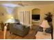 Cozy living room features comfortable seating, a ceiling fan, and a built-in media center at 3006 Bonfire Beach Dr # 102, Kissimmee, FL 34746