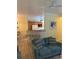 Cozy living room features a comfortable blue sofa and breakfast bar to the kitchen at 3006 Bonfire Beach Dr # 102, Kissimmee, FL 34746