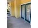 Inviting outdoor patio area with double doors and yellow exterior at 3006 Bonfire Beach Dr # 102, Kissimmee, FL 34746
