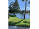 Beautiful view of the pond with palm trees and waterfront scenery at 3006 Bonfire Beach Dr # 102, Kissimmee, FL 34746