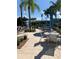 Relaxing pool area with tables, chairs, and umbrellas for residents at 3006 Bonfire Beach Dr # 102, Kissimmee, FL 34746