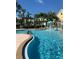 View of the community pool with splash fountains and lush landscaping at 3006 Bonfire Beach Dr # 102, Kissimmee, FL 34746