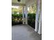 Covered porch with white columns and lush landscaping at 3006 Bonfire Beach Dr # 102, Kissimmee, FL 34746