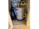 Utility closet with water heater, vacuum cleaner, and plumbing components at 3006 Bonfire Beach Dr # 102, Kissimmee, FL 34746