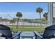 Balcony with lake view and seating for two at 3088 Parrot Head Pl, Kissimmee, FL 34747