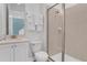 Clean and modern bathroom with a walk-in shower and white vanity at 3088 Parrot Head Pl, Kissimmee, FL 34747