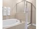 Bathroom with soaking tub and walk-in shower at 3088 Parrot Head Pl, Kissimmee, FL 34747