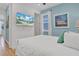 Bright bedroom with a queen bed and a wall-mounted TV at 3088 Parrot Head Pl, Kissimmee, FL 34747