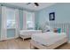 Twin bedroom with light walls and hardwood floors at 3088 Parrot Head Pl, Kissimmee, FL 34747