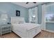 Bright bedroom with a comfortable queen-size bed and hardwood floors at 3088 Parrot Head Pl, Kissimmee, FL 34747