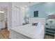Bedroom with white sleigh bed, blue walls, and ensuite bathroom at 3088 Parrot Head Pl, Kissimmee, FL 34747