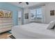 Main bedroom with large windows and a TV at 3088 Parrot Head Pl, Kissimmee, FL 34747