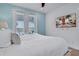 Primary bedroom with a large TV and balcony access at 3088 Parrot Head Pl, Kissimmee, FL 34747