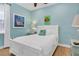 Bedroom with white sleigh bed, coastal art, and light blue walls at 3088 Parrot Head Pl, Kissimmee, FL 34747