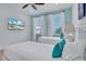 Bedroom with large TV, two beds, and light wood floors at 3088 Parrot Head Pl, Kissimmee, FL 34747