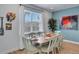 Casual dining area with light wood table and seating for six, near a window at 3088 Parrot Head Pl, Kissimmee, FL 34747