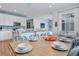 Well-lit dining area with a rustic wooden table and light teal chairs at 3088 Parrot Head Pl, Kissimmee, FL 34747