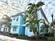 Charming light blue house with palm trees and green landscaping at 3088 Parrot Head Pl, Kissimmee, FL 34747