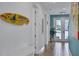 Interior hallway with light blue walls and tropical decor at 3088 Parrot Head Pl, Kissimmee, FL 34747