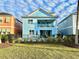 Two-story light blue house with private pool and fenced backyard at 3088 Parrot Head Pl, Kissimmee, FL 34747