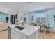 Kitchen with island, double sink, and view into dining and living areas at 3088 Parrot Head Pl, Kissimmee, FL 34747