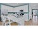 Bright kitchen featuring white cabinets, stainless steel appliances, and an island with seating at 3088 Parrot Head Pl, Kissimmee, FL 34747