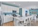 Modern kitchen with white cabinets, stainless steel appliances, and an island at 3088 Parrot Head Pl, Kissimmee, FL 34747