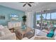 Relaxing living room with comfortable sofas, a coffee table, and sliding glass doors to the patio at 3088 Parrot Head Pl, Kissimmee, FL 34747