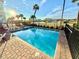 Private heated pool and spa with lounge chairs at 3088 Parrot Head Pl, Kissimmee, FL 34747