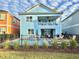 Back view of two-story house with private pool, fenced yard, and landscaping at 3088 Parrot Head Pl, Kissimmee, FL 34747