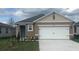 Charming one-story home featuring a two-car garage, neutral color palette, and landscaped front yard at 3564 Fort Mellon Ln, Sanford, FL 32773