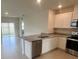 Open-concept kitchen with stainless steel appliances, granite countertops, and abundant natural light at 3564 Fort Mellon Ln, Sanford, FL 32773