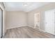Spacious bedroom with wood-look floors and en-suite bathroom at 3846 Long Grove Ln, Port Orange, FL 32129