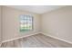 Bedroom with wood-look floors and large window at 3846 Long Grove Ln, Port Orange, FL 32129