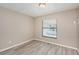 Bedroom with wood-look floors and view of patio at 3846 Long Grove Ln, Port Orange, FL 32129