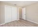 Bedroom with double-door closet and wood-look floors at 3846 Long Grove Ln, Port Orange, FL 32129