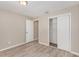 Bedroom with wood-look floors and access to hallway at 3846 Long Grove Ln, Port Orange, FL 32129