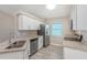 Modern kitchen with white cabinets, granite countertops, and stainless steel appliances at 3846 Long Grove Ln, Port Orange, FL 32129
