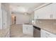 Modern kitchen with white cabinets, granite countertops, and stainless steel appliances at 3846 Long Grove Ln, Port Orange, FL 32129